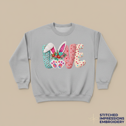 Gray sweatshirt with Easter LOVE design featuring bunny ears, flowers, and paw prints
