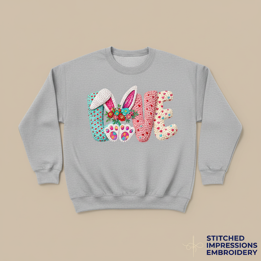 Gray sweatshirt with Easter LOVE design featuring bunny ears, flowers, and paw prints